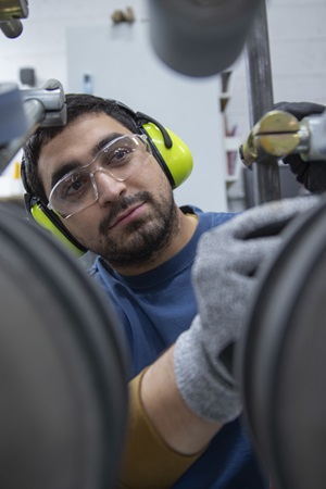 Worker in warehousing wearing ear protection