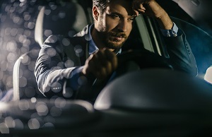 A tired male driver by the wheel