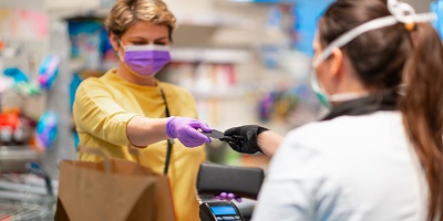 Woman in a mask at the checkout